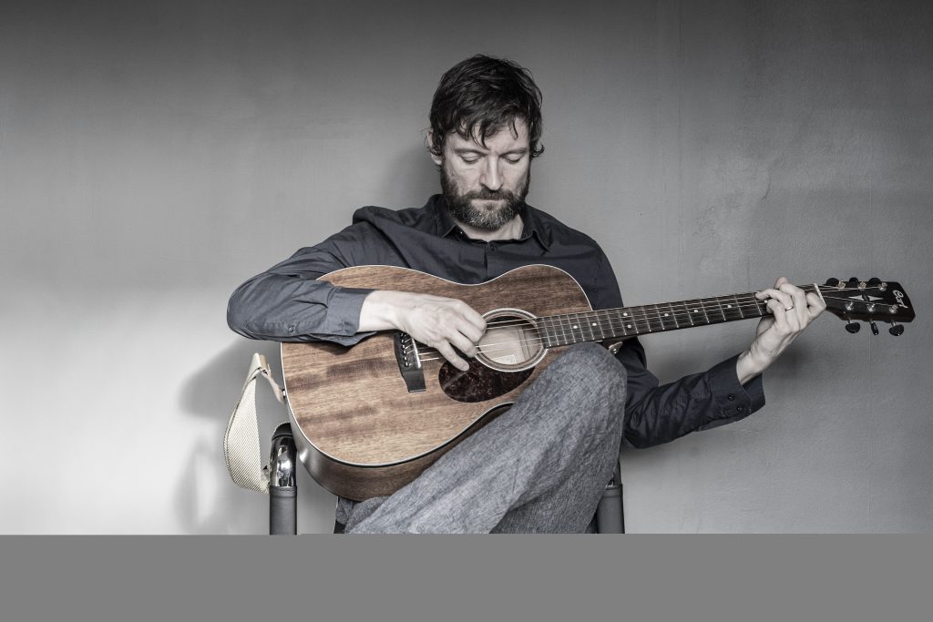 Ian David Green playing guitar.