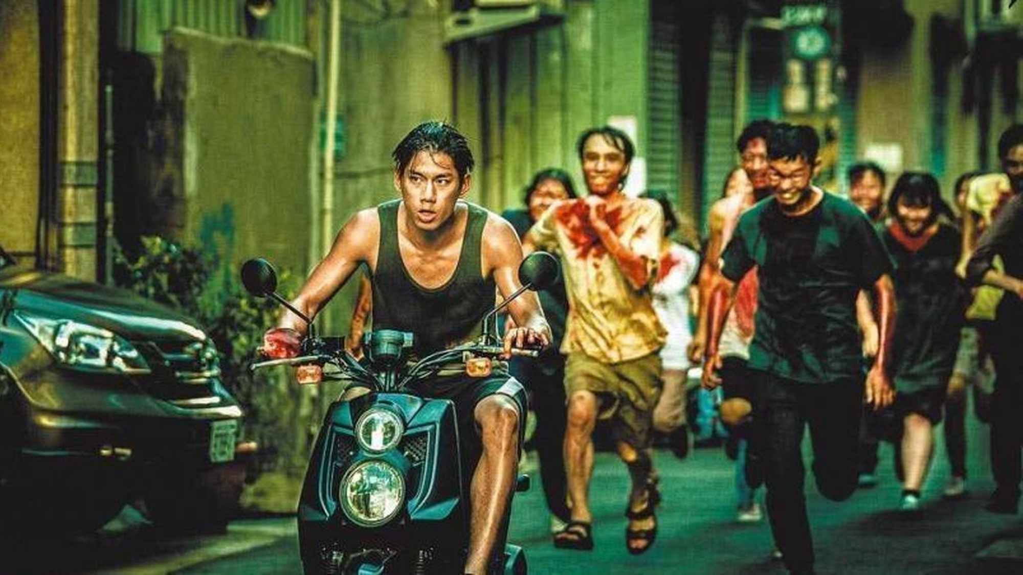 Jim on a moped being chased by the infected