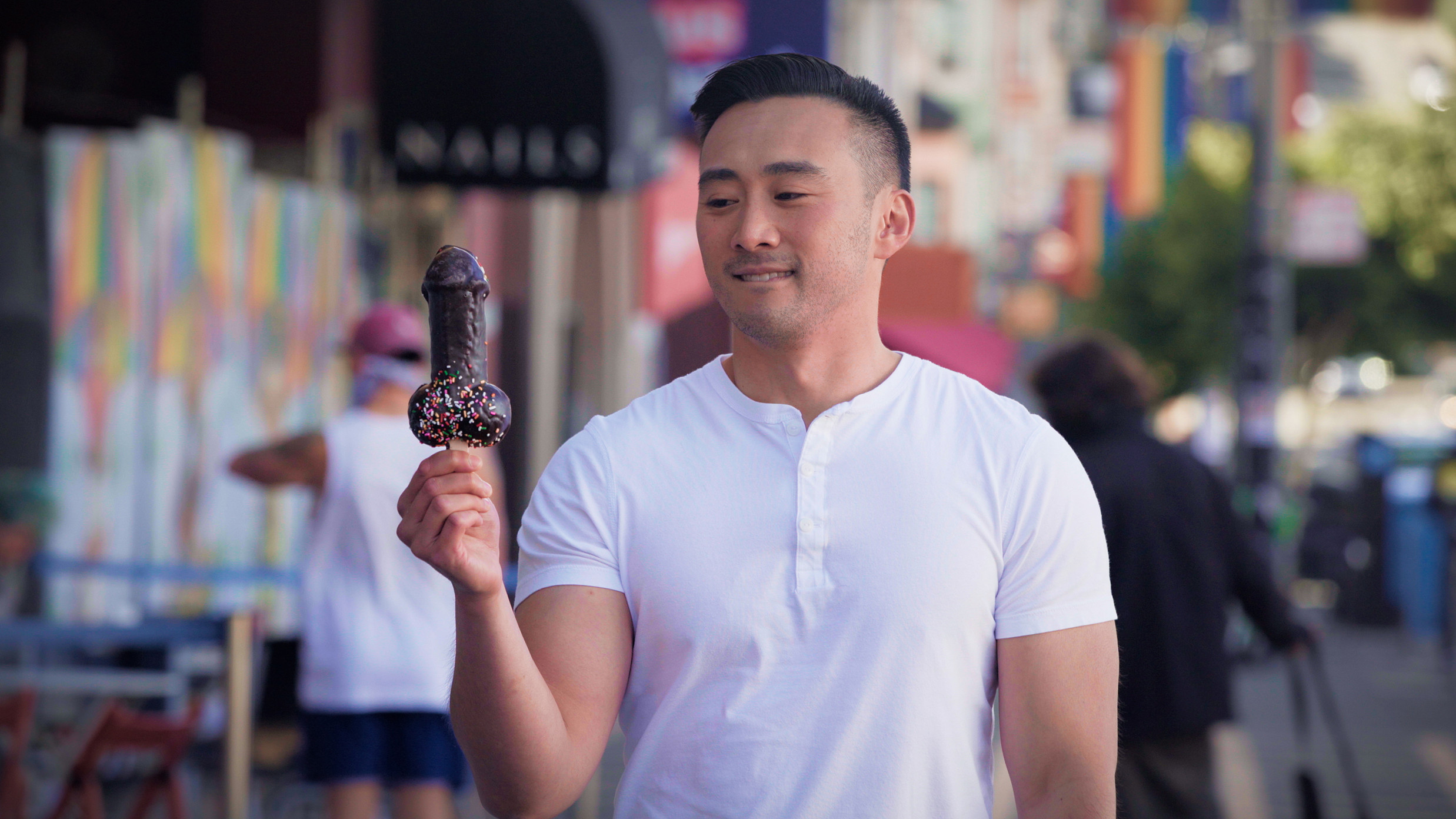 Alex Liu holding a chocolate penis